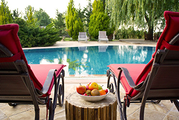 two seats overlooking a pool