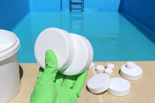 White large tablet of chlorine in the hand for pool chlorine levels