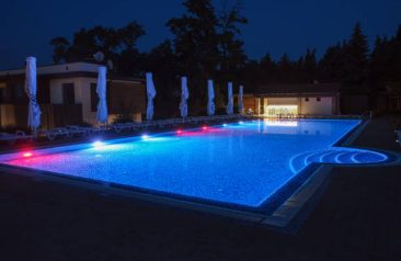 Summer outdoor pool with lighting at night